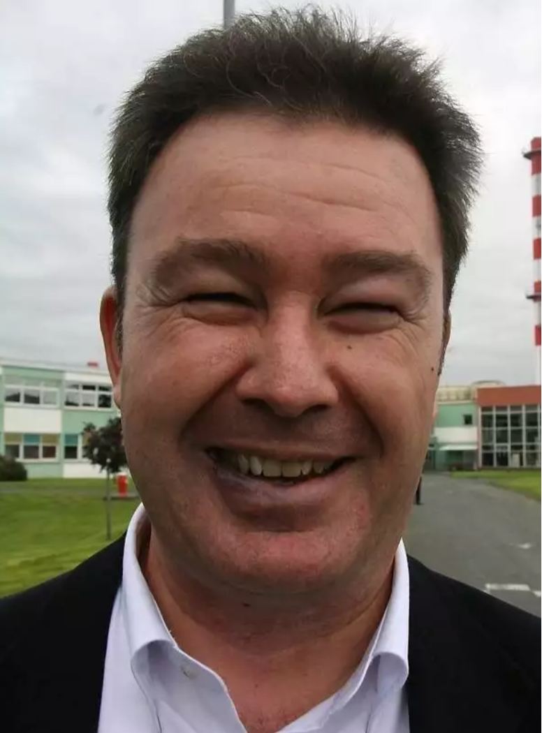 CEO de negocio contento mirando a cámara con traje después de trabajar con consultoria